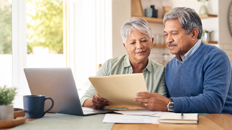 Older adults reviewing government benefit information together at home